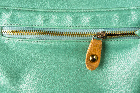 closeup of the fittings and seams on green leather hand bagの写真素材