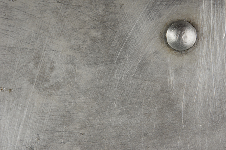 texture of the old aluminum surface with rivets, corrosion, scratches, and dentsの写真素材