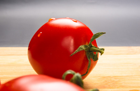 still life - ripe small tomatoes on wooden backgroundの写真素材