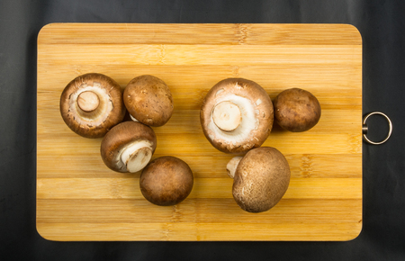 large Royal mushroom champignons on a wooden cutting Boardの写真素材