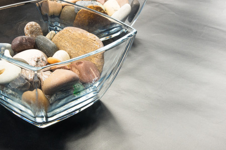 multicolored decorative pebbles in glass containers on a black backgroundの写真素材
