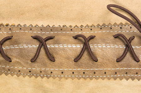 closeup of the fittings and seams on brown leather hand bag