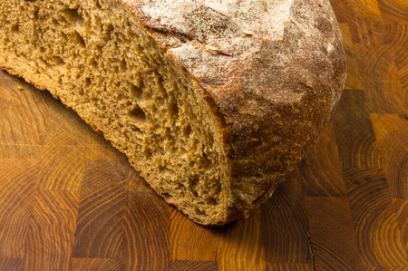 cut malt bread handmade on wooden background