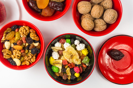 various dried fruits, mixed nuts and walnuts on the white backgroundの写真素材