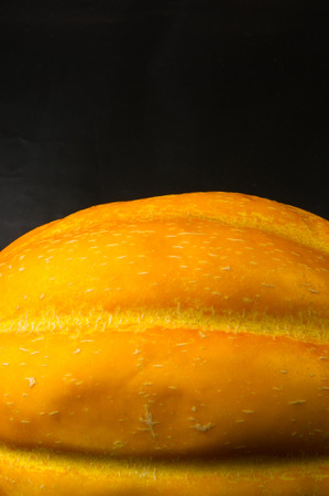 still life - ripe juicy Ethiopian melon on black backgroundの写真素材