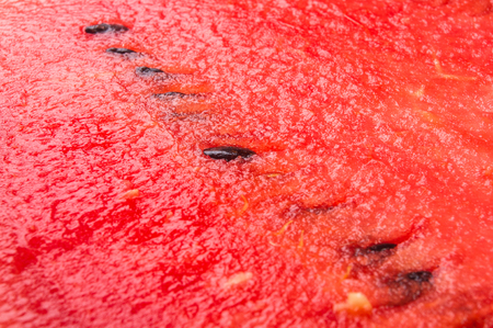 half of ripe watermelon on a black backgroundの写真素材