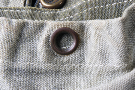 closeup of buckles, clasps, zippers, pockets, fasteners, fittings and seams in the green backpack