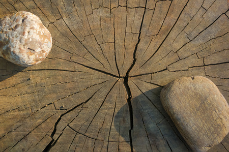 Spa beautiful and unusual decorative pebbles on the old cracked wooden backgroundの写真素材