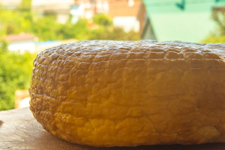 head of traditional Adygei cheese handmade on wooden Boardの写真素材