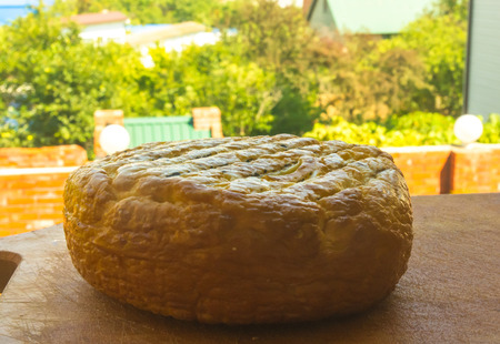 head of traditional Adygei cheese handmade on wooden Boardの写真素材