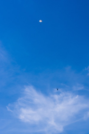 dropping parachutists from a helicopter over the seaの写真素材