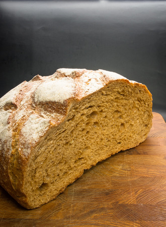 cut malt bread handmade on wooden background