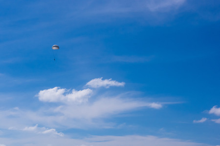 dropping parachutists from a helicopter over the seaの写真素材