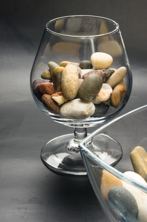 multicolored decorative pebbles in glass containers on a black backgroundの写真素材