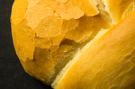 fresh braided loaf of white wheat bread on black backgroundの写真素材