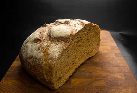cut malt bread handmade on wooden background