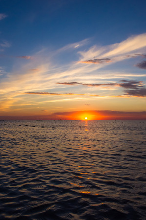 Summer sea sunset, the sun, waves and clouds, beautiful dramatic lightingの写真素材