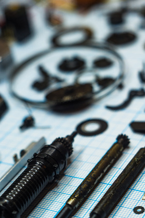 parts are completely disassembled old retro film SLR camera on graph paper, close-upの写真素材