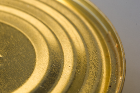 a lid or Base of Food yellow tin cans, macro, close up