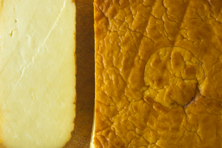 cut head of traditional Adygei cheese handmade on wooden Board