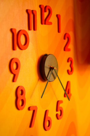 large wall clock with colorful numbers, close up
