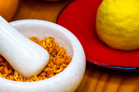 White marble mortar and pestle with the dried orange zestの写真素材