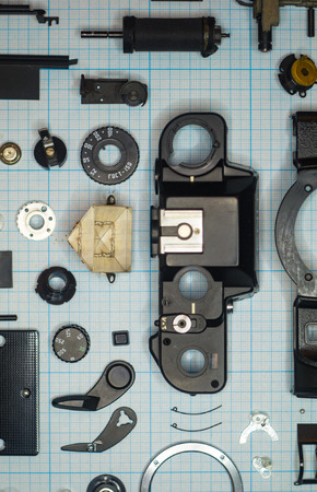 parts old retro film SLR camera on graph paperの写真素材