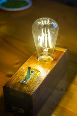 Light fixture handmade in vintage style, wooden case, copper finish, led lampの写真素材