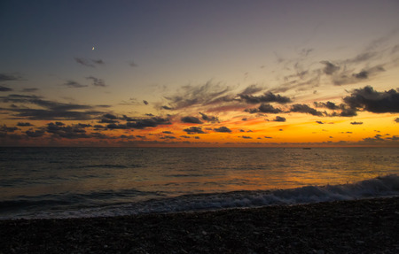 Summer sea sunset, the sun, waves and clouds, beautiful dramatic lightingの写真素材