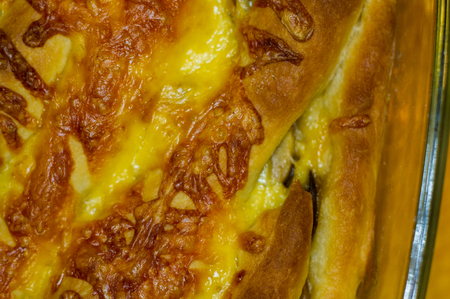 baked In the oven homemade pie stuffed with cheese and mushrooms on a wooden tableの写真素材