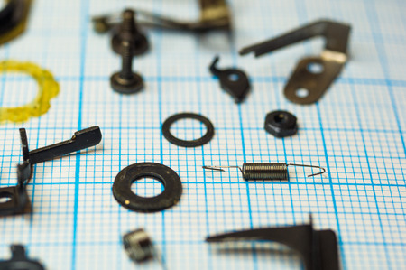 parts are completely disassembled old retro film SLR camera on graph paper, close-upの写真素材