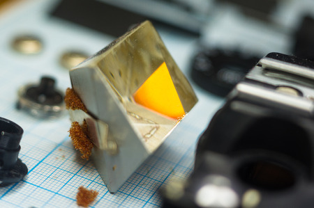 parts are completely disassembled old retro film SLR camera on graph paper, close-upの写真素材