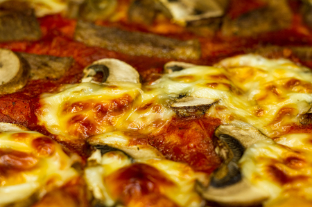 pizza with cheese, mushrooms and meatの写真素材