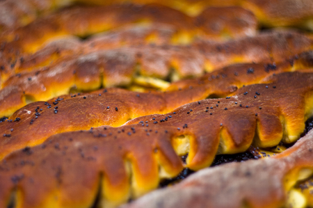 baked homemade rustic pie with apples, poppy seeds and jam, close-up, selective focus