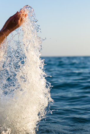 large transparent splashes sea water on a warm Sunny day, close-upの写真素材