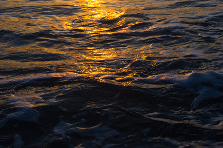 Summer sea sunset, the sun, waves and clouds, beautiful dramatic lightingの写真素材