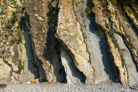 rock formations and stones of the sea coast, weathered and smoothed by wavesの写真素材