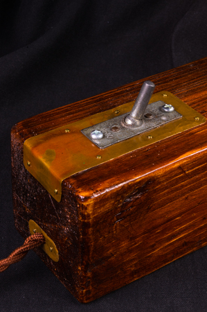 Light fixture handmade in vintage style, wooden case, copper finish, led lamp on a black background.の写真素材
