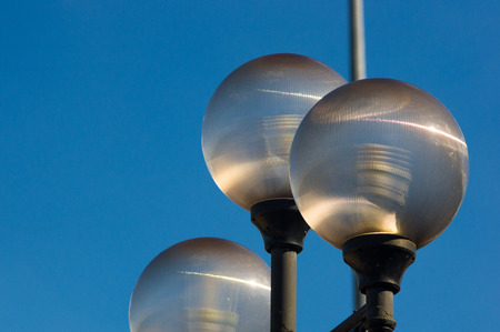 city skyline - classic lamp post with locks of lovers at sunset