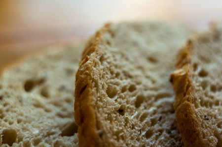sliced whole wheat breads on a chopping Boardの写真素材