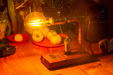 Light fixture handmade in vintage style, wooden case and radio tube, copper finish, led lampの写真素材