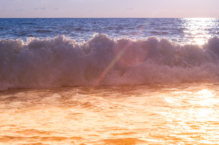 Summer sea sunset, the sun, waves and clouds, beautiful dramatic lightingの写真素材