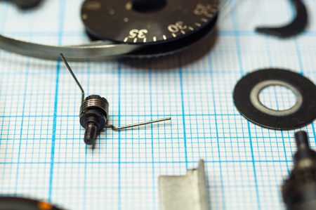 parts are completely disassembled old retro film SLR camera on graph paper, close-upの写真素材