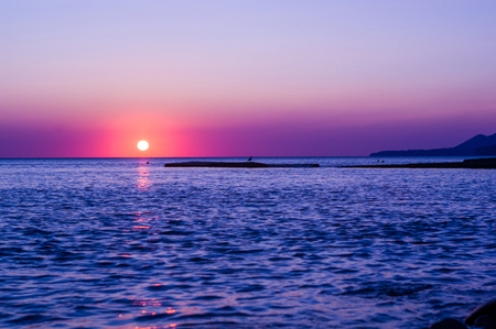 Summer sea sunset, the sun, waves and clouds, beautiful dramatic lightingの写真素材