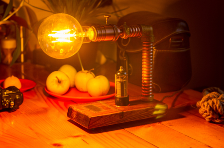 Light fixture handmade in vintage style, wooden case and radio tube, copper finish, led lampの写真素材