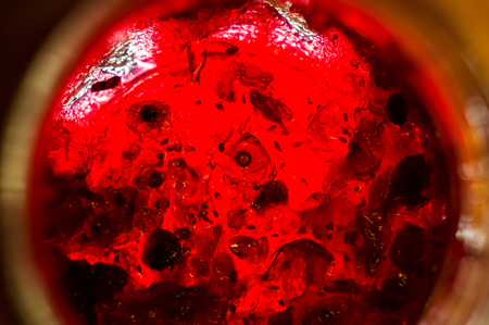 Bright translucent red currant jam in a glass jar, close-up, macro photoの写真素材