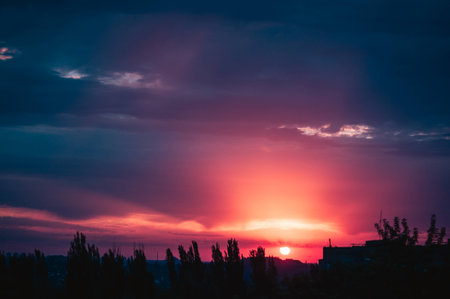 Landscape with dramatic light - beautiful golden sunset with saturated sky and clouds, peaceful nature serene background.の写真素材