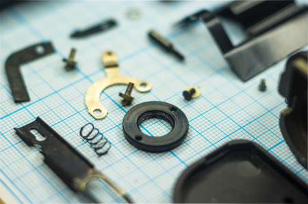 parts are completely disassembled old retro film SLR camera on graph paper, close-upの写真素材