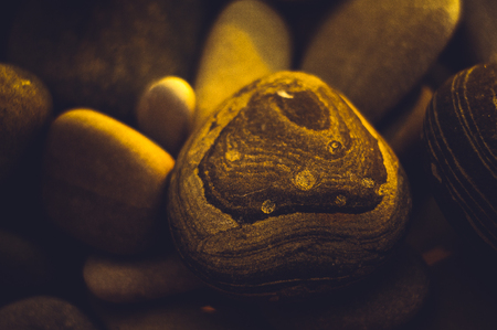 boulders and colorful pebbles on the beach on a warm summer day