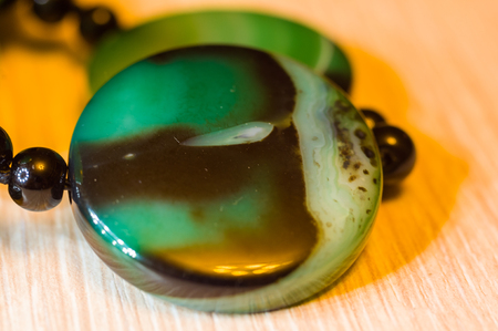 Large polished beads of beautiful translucent green agate gemstone, close-up, macro photoの写真素材